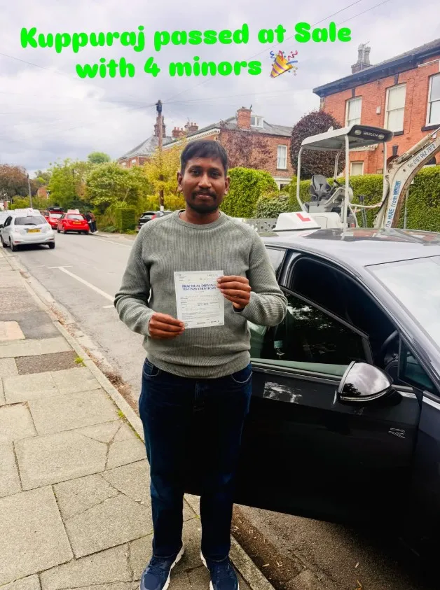 Kuppuraj with their pass certificate beside a Learn Local car