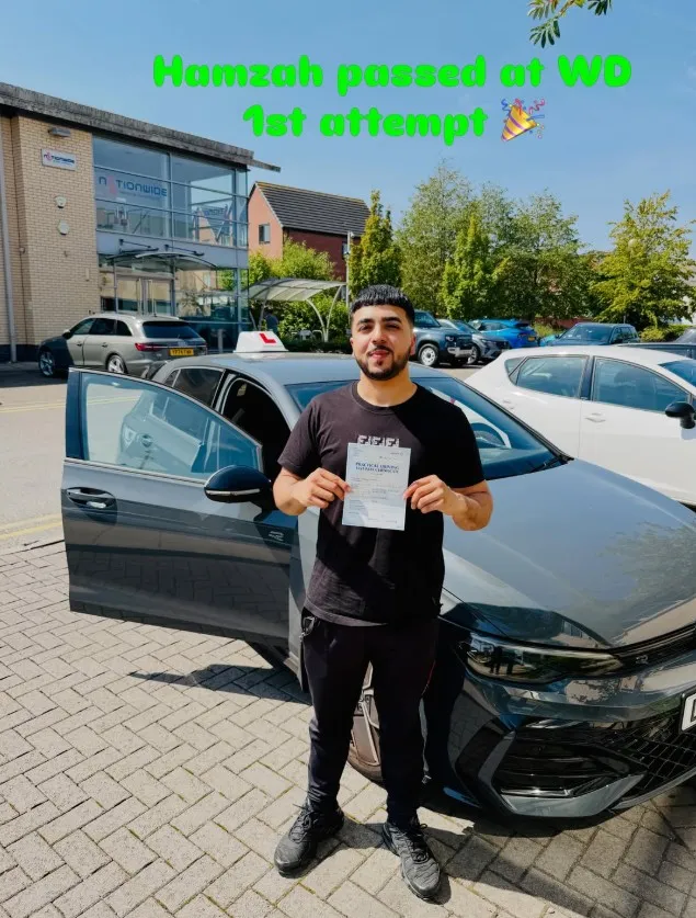 Lucy with their pass certificate beside a Learn Local car