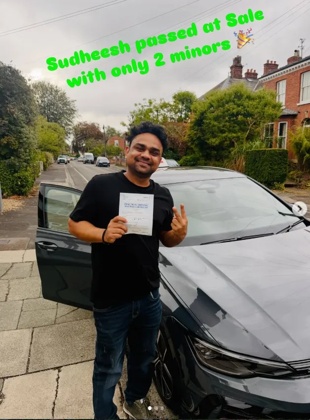 Sudheesh with their pass certificate beside a Learn Local car