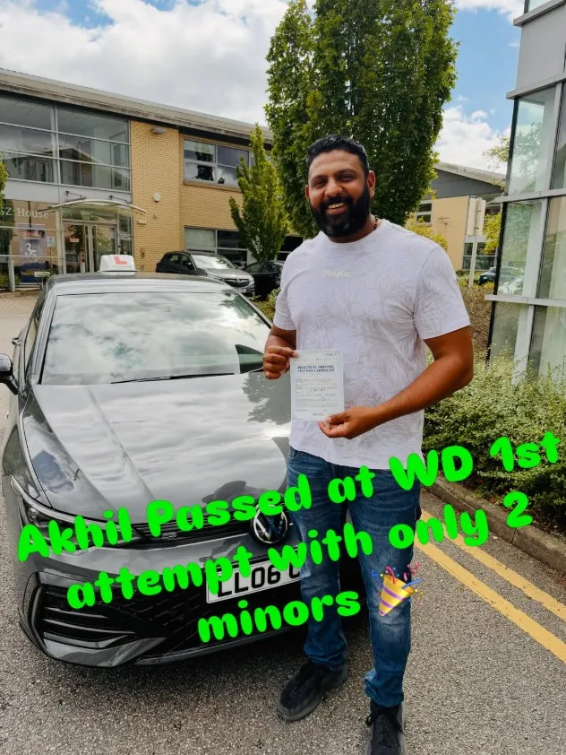 Umair with their pass certificate beside a Learn Local car
